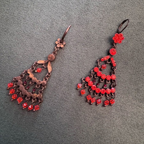 Vintage metal earrings used with red-orange crystals