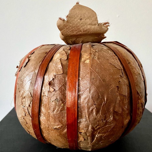 Decorative pumpkin wrapped with dried leaves like new