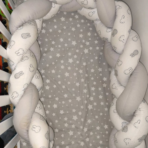 Baby braided crib bumper used in gray and white