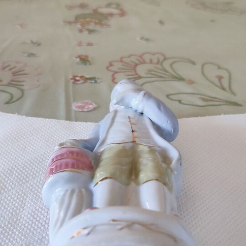 Vintage porcelain figurine Victorian man with bird and cage