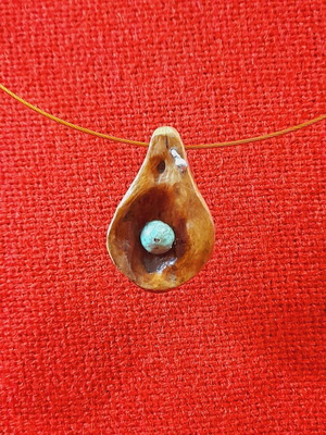 Handmade necklace with carved wood and green semi-precious stone