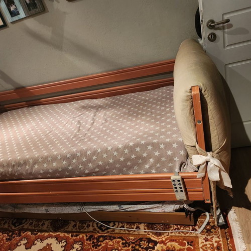 Electric hospital bed used with headboard