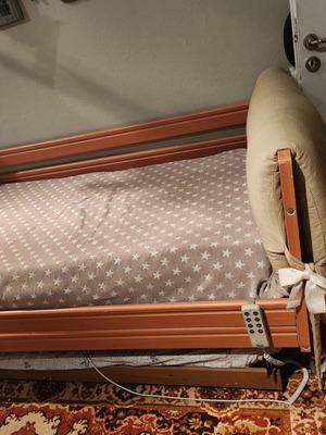 Electric hospital bed used with headboard