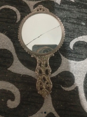 Vintage hand mirror with crack