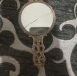 Vintage hand mirror with crack