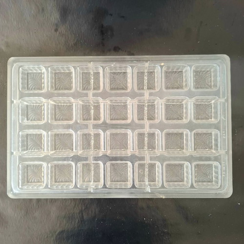 Polycarbonate mold for square chocolates used with feather design