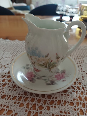 Vintage porcelain milk jug with saucer
