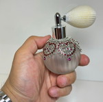 Vintage perfume bottle with pump, decorative hearts and crystals