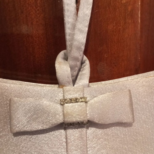 Silver satin evening bag with bow and wrist strap