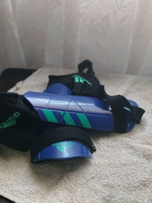 Blue green shin guards used, good condition