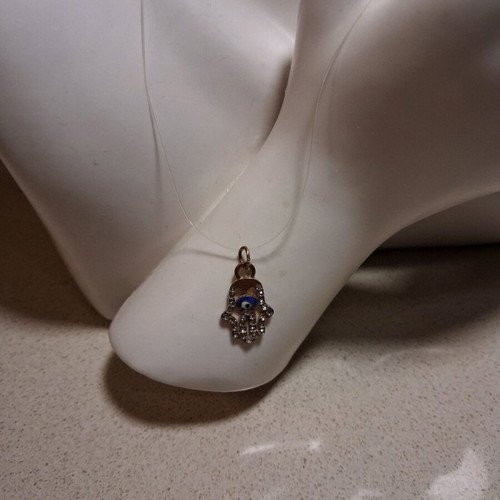 Hamsa pendant with transparent synthetic fishing line used