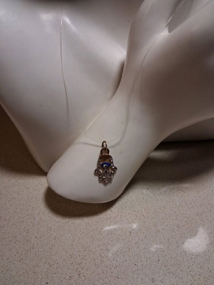 Hamsa pendant with transparent synthetic fishing line used