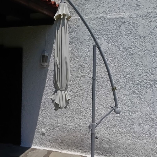 Garden umbrella used, white fabric with support plates