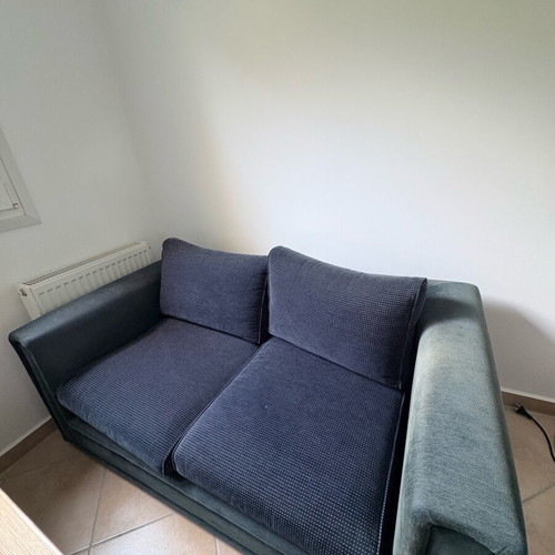 Two dark blue used two-seater sofas set