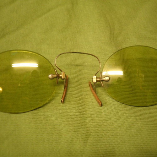 Antique eyeglasses with green lens used