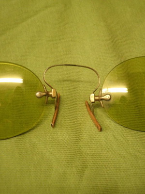 Antique eyeglasses with green lens used