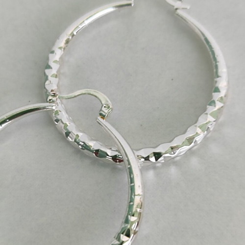 Silver-tone hoop earrings like new with diamond-cut texture
