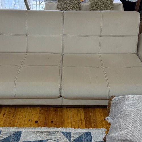 Three-seater sofas used with two stools and storage space