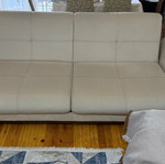Three-seater sofas used with two stools and storage space