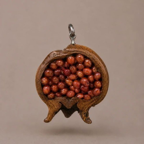 Handmade pomegranate pendant from natural material, like new