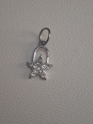 Charm star decorated with sparkling stones used, silver
