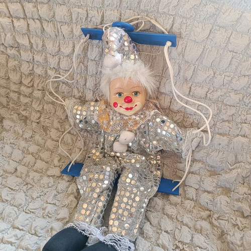 Vintage porcelain clown on swing like new, decorative