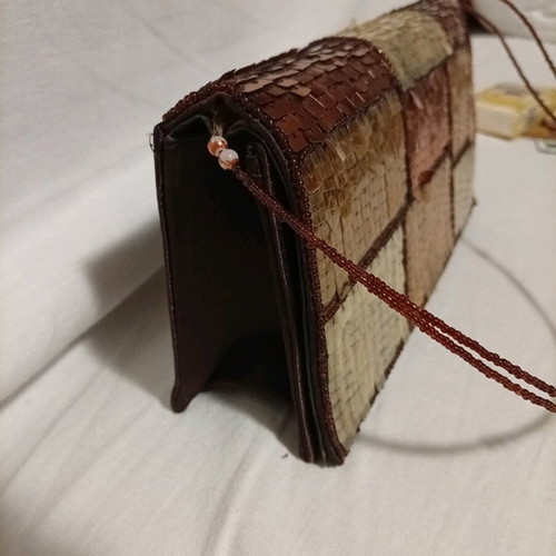 Official hand bag like new in brown shades with sequins