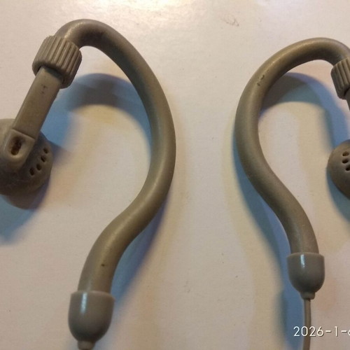 Over the ear headphones used with anatomical tube behind the ear