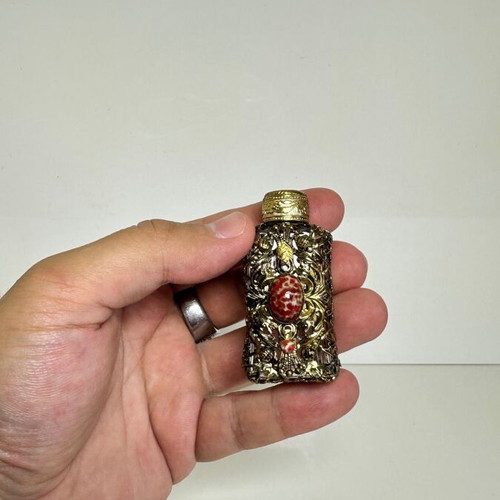 Vintage perfume flacon with filigree metalwork and red cabochon