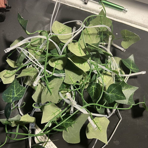 LED string lights with artificial leaves