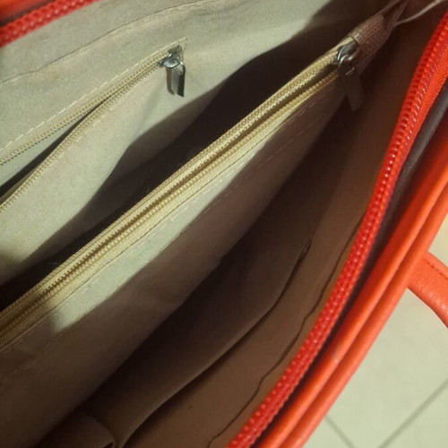 Red shoulder bag used with multiple compartments and zippers