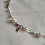 Handmade necklace with metal frame and plastic and metallic beads
