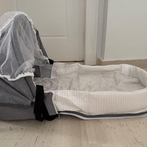 Portable travel baby cot with mosquito net new, converts to bag