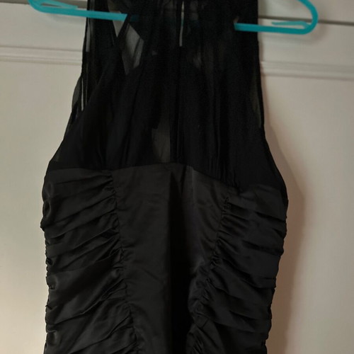 Twentyone L, women's black blouse, made of satin and muslin. The bow at the back.