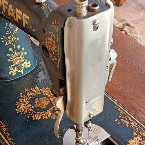 Antique sewing machine used with furniture and accessories