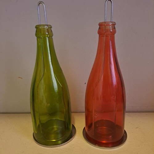 Set of 2 decorative candle holders with metal base and colored glass bottles