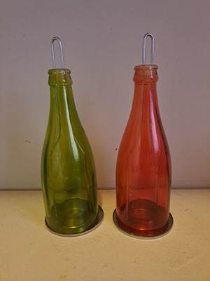Set of 2 decorative candle holders with metal base and colored glass bottles