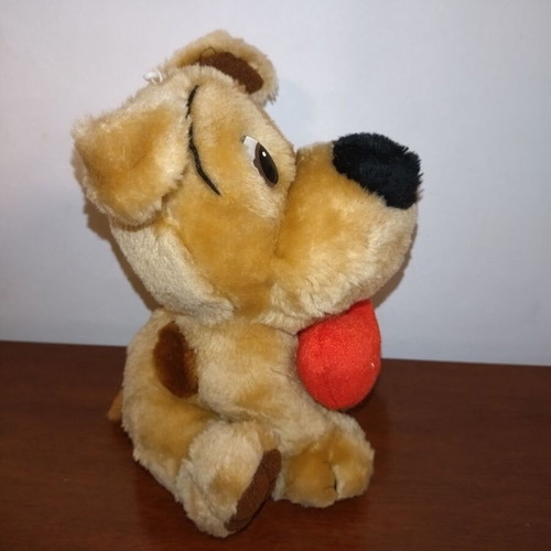 Plush dog used with red heart