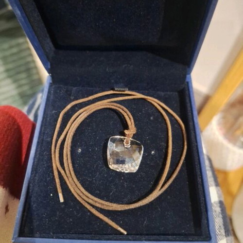 Swarovski necklace like new, transparent with brown cord