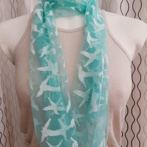 Lightweight scarf used, semi-transparent green with white hummingbirds