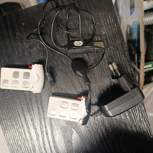 Syma drones used with controllers, two batteries and extra propellers