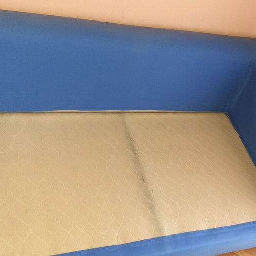 Two-seater sofa used without two back cushions