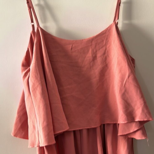 One-piece jumpsuit size S, like new, with ruffles and side openings