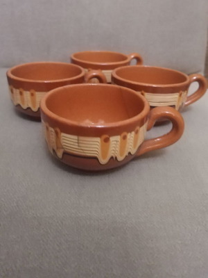 Set of 4 ceramic coffee cups used, brown with traditional design