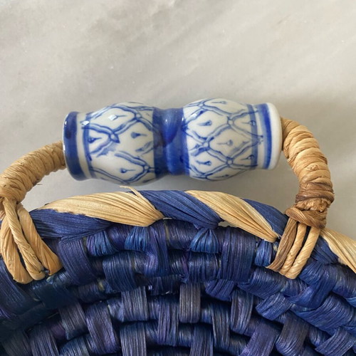 Blue handmade wicker basket with painted porcelain handles like new