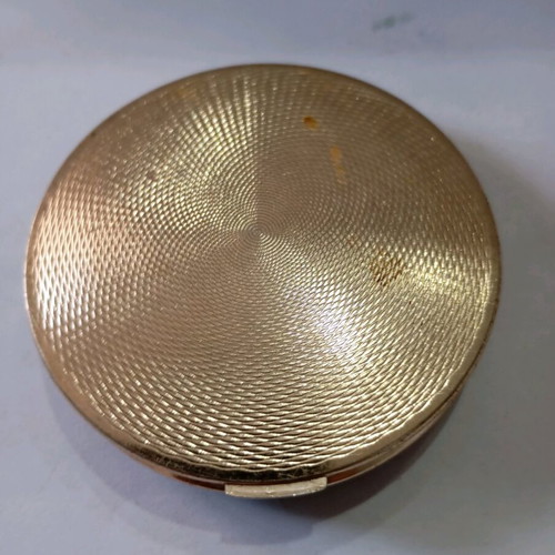 Powder used in vintage metal box with dog decoration