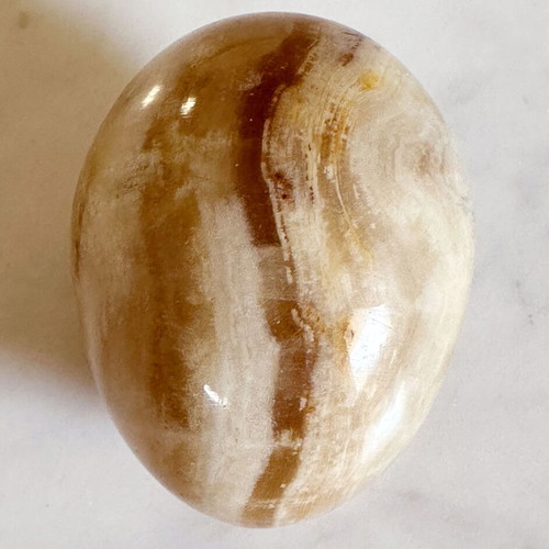 Vintage decorative egg from natural onyx stone in carved silver-plated base used