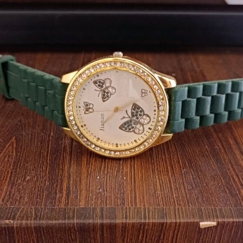 Women's watch like new with green rubber strap and butterfly dial