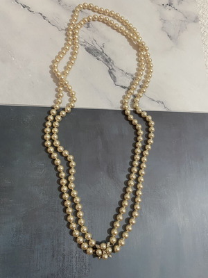Long pearl necklace with silver flower used