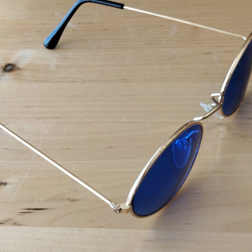 Oval sunglasses new with blue lenses and golden frames